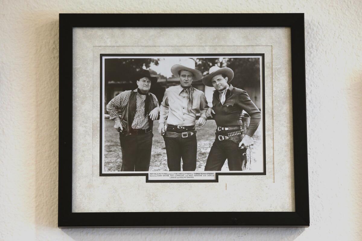 A framed photo of John Wayne, Max Terhune and Ray Corrigan.