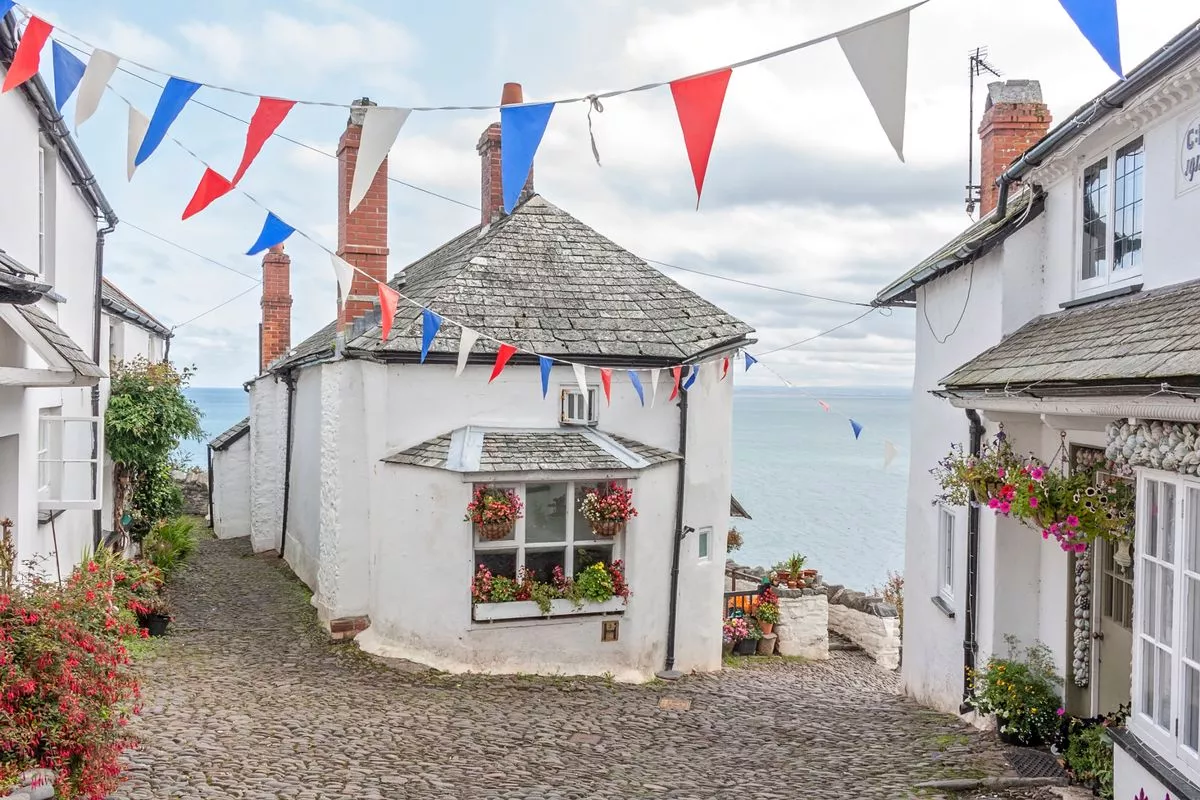 Bunting and flowers adorn the cottages overlooking he sea at Clovelly in Devon