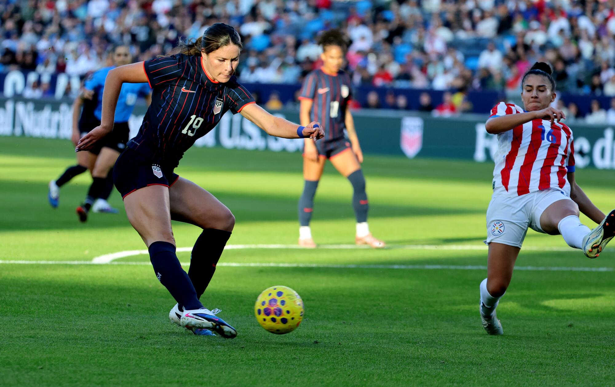 U.S. forward Emma Sears, left, scores past Paraguay defender Fiorella Martinez in the second half Saturday.