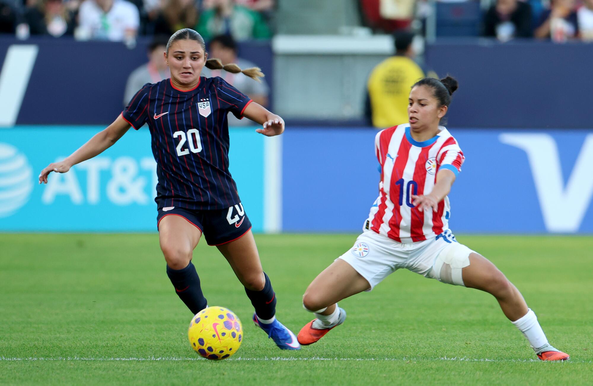 U.S. defender Gisele Thompson, left, moves the ball past Paraguay midfielder Fatima Acosta in the second half Saturday.