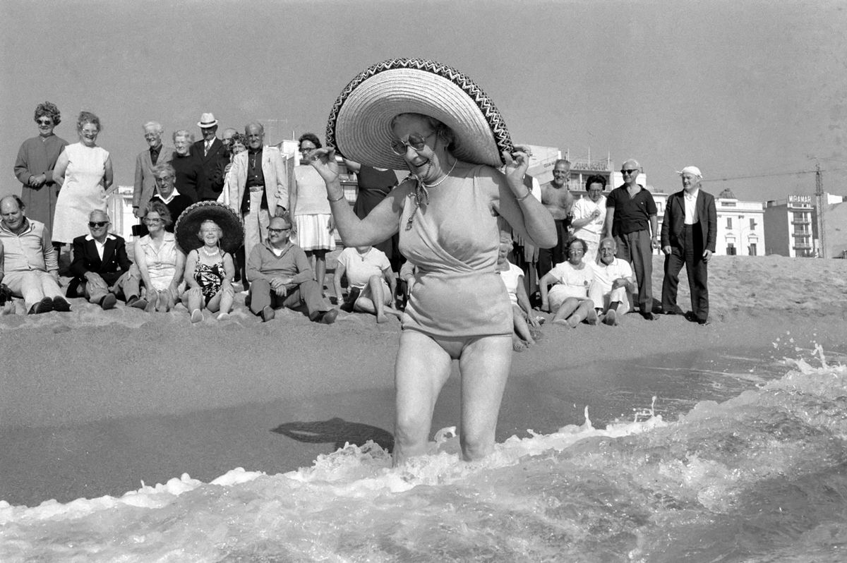 In Nov 1971, at Lloret de Mar on the Costa Brava several hundred old-age pensioners are enjoying the beautifully warm sunshine. Bathing in the sea is Mrs. Lillian Bevington, 63, from Thames Ditton