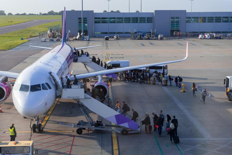 Passengers boarding a Wizz Air airplane at London Luton Airport.