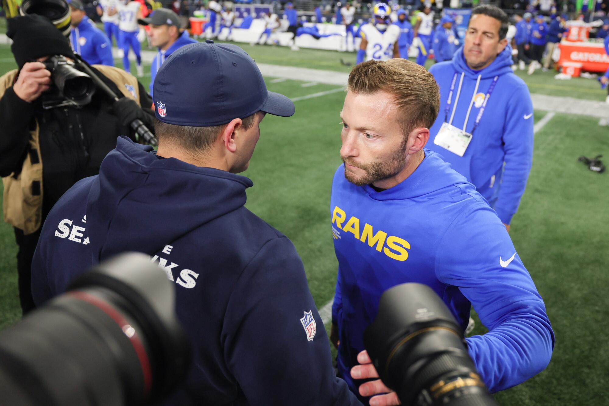 Rams coach Sean McVay, right, shakes hands with Seattle Seahawks coach Mike Macdonald.