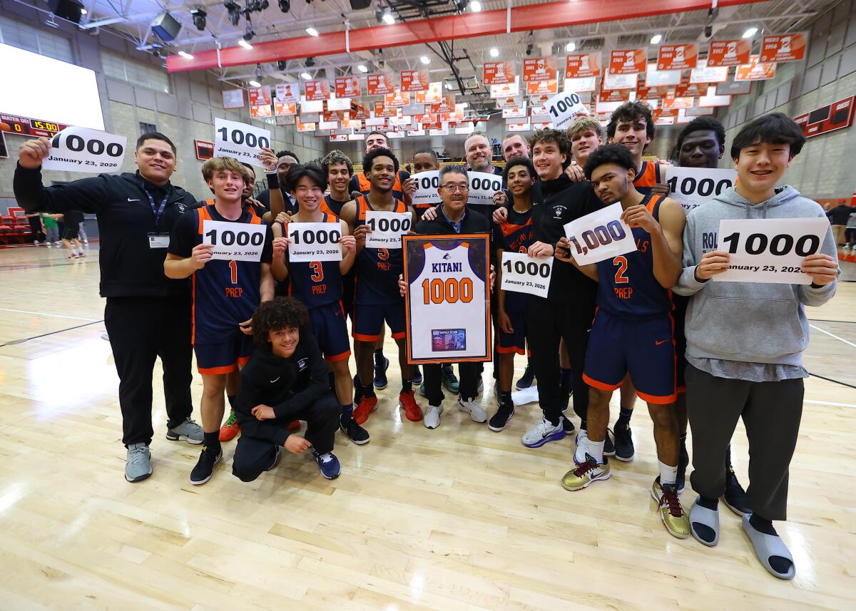 Harvey Kitani is surrounded by his Rolling Hills Prep players after earning his 1,000th career victory on Friday night.