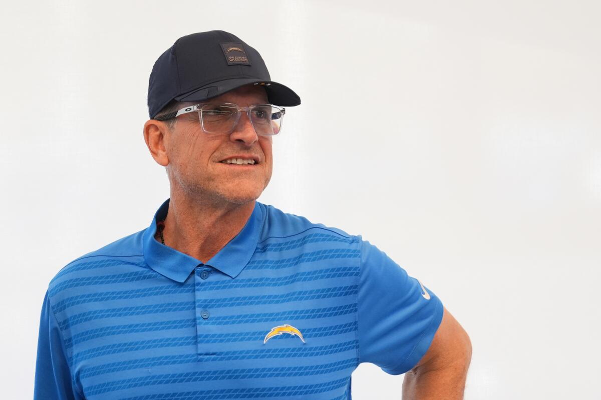 Chargers coach Jim Harbaugh attends Mike McDaniel's introductory news conference on Tuesday.