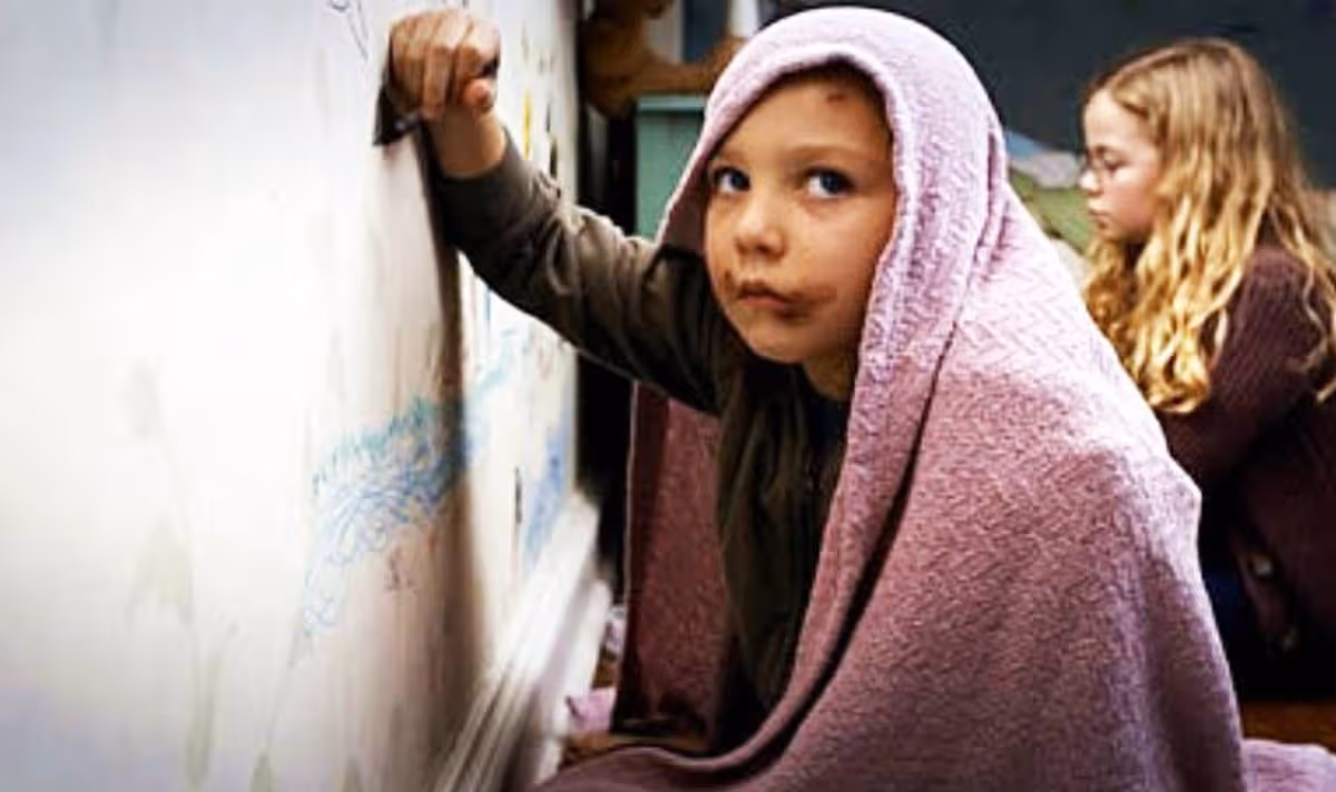 Two young girls drawing on whiteboard