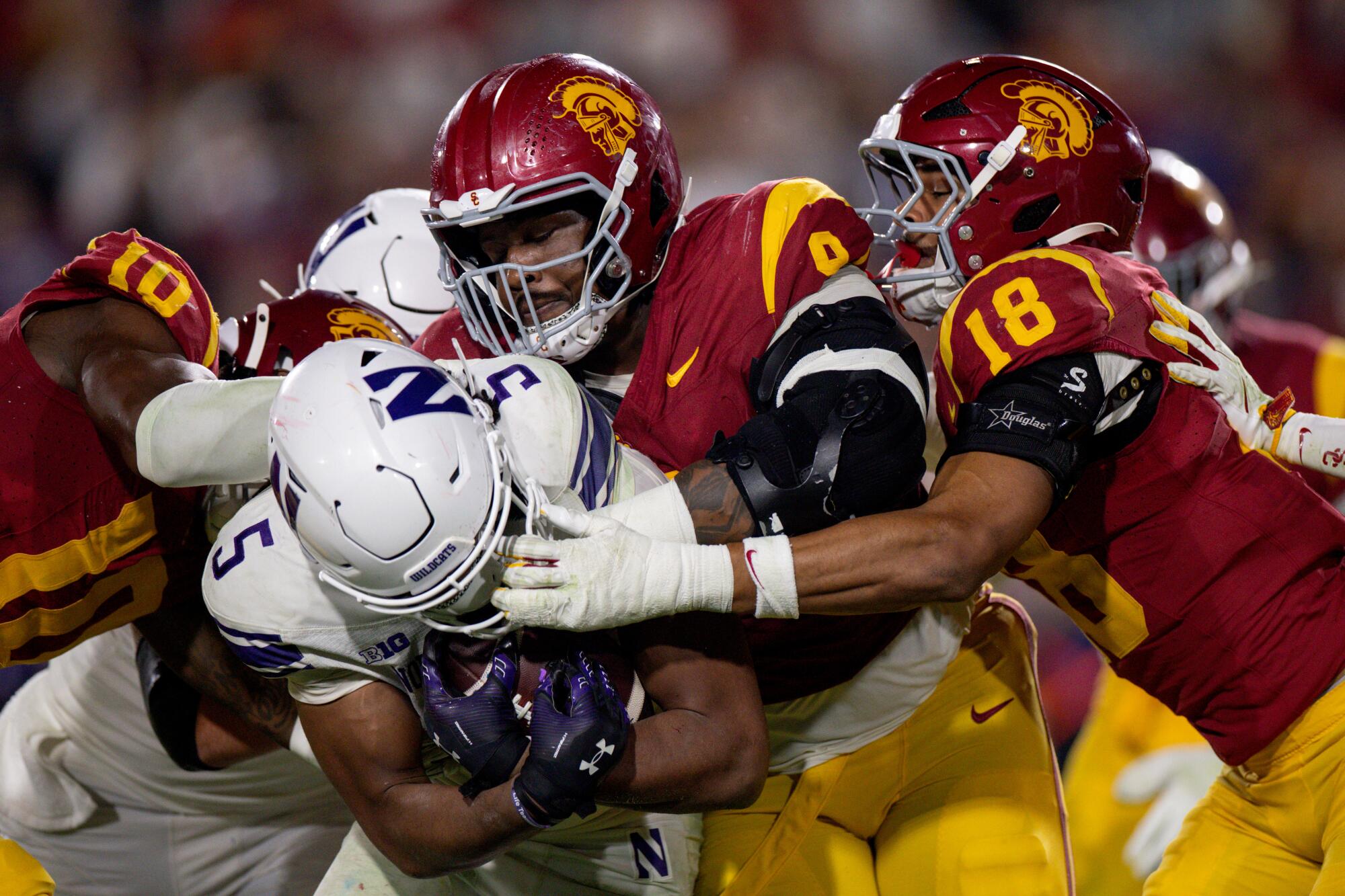 Trojans fans hope Gary Patterson's hire leads to more of this, when three USC players brought down a running back last year.