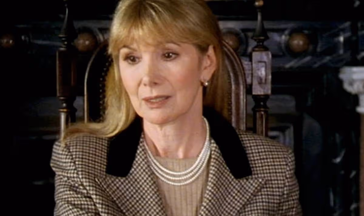 A woman in tweed looks sad