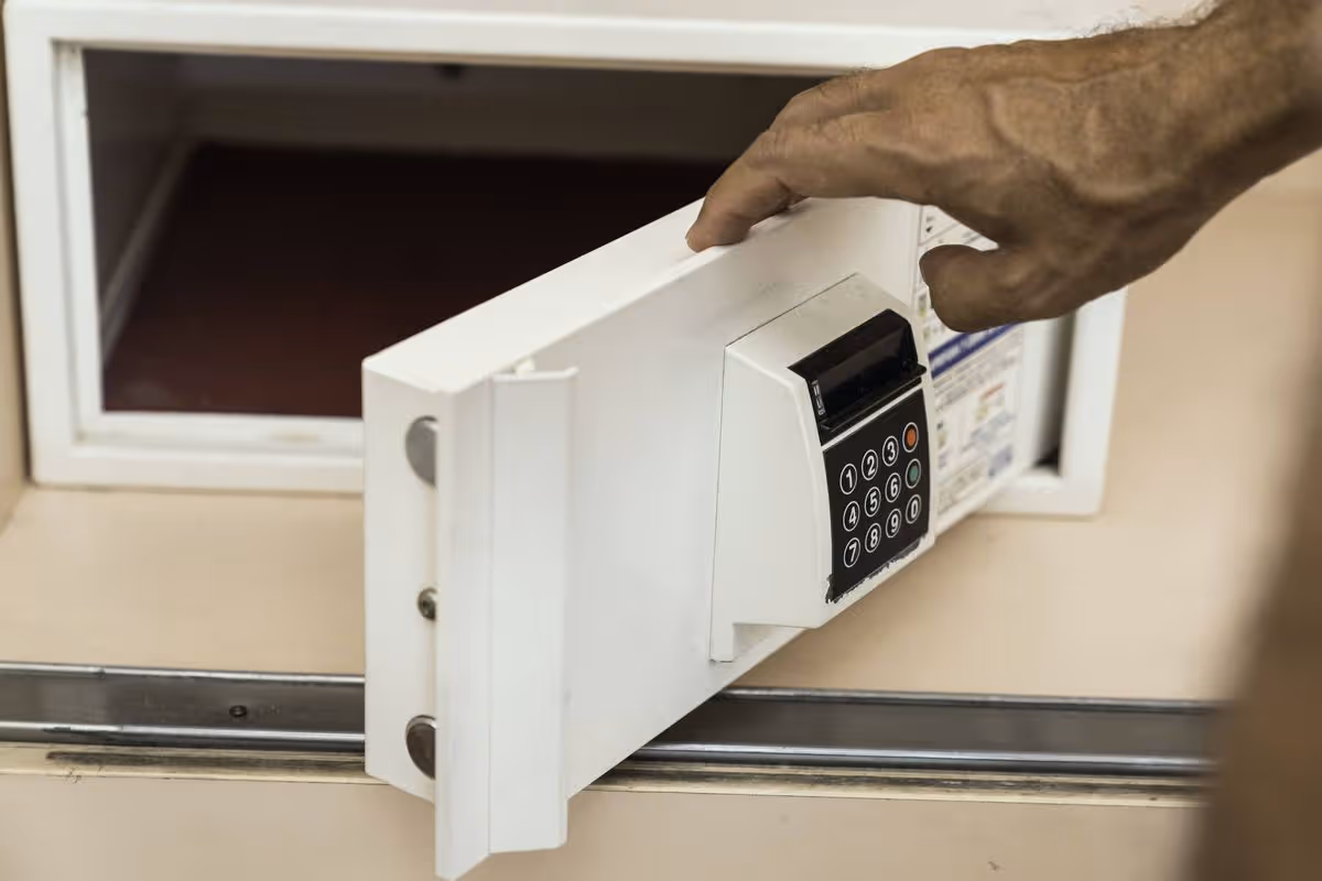 Unrecognizable person opening a hotel room safe