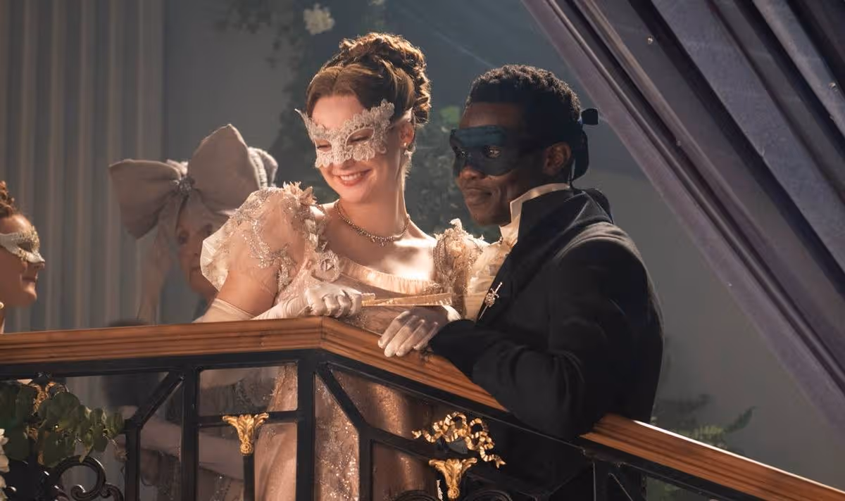 A man and a woman stand on the stairs