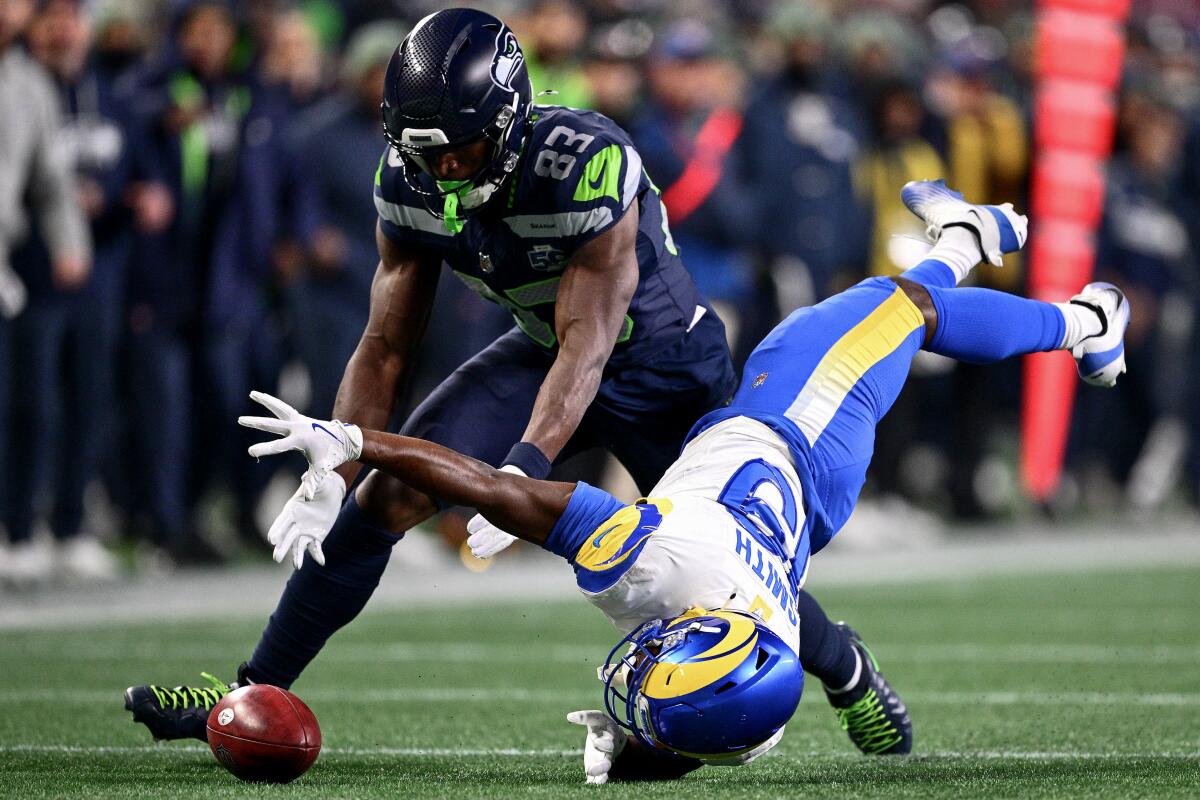 Rams kick returner Xavier Smith muffs a punt as Seattle's Dareke Young recovers the ball in the third quarter.