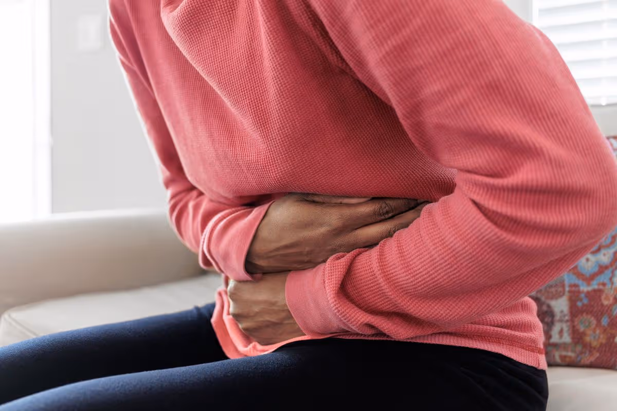 Person experiencing stomach symptoms