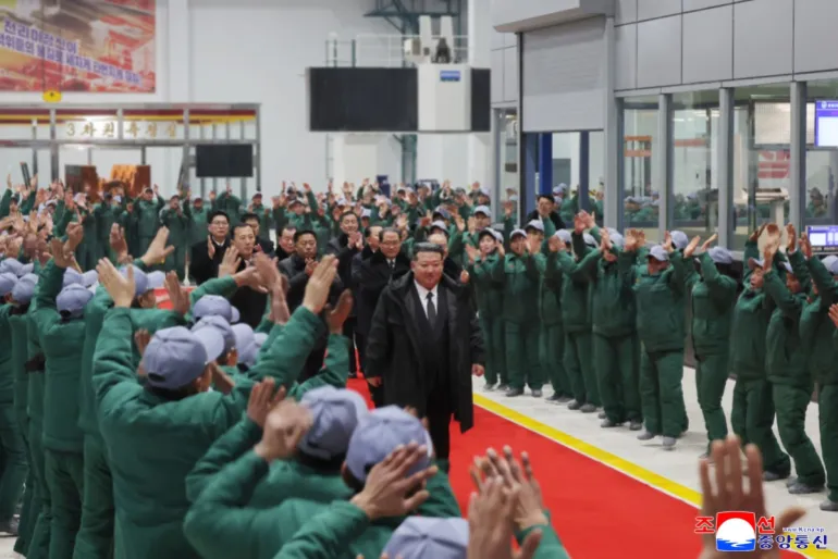 This picture taken on January 19, 2026 and released by North Korea's official Korean Central News Agency (KCNA) on January 20, 2026 shows North Korean leader Kim Jong Un (C) attending the completion ceremony for the first phase of renovation and modernisation of the Ryongsong Machine Complex in South Hamgyong Province, North Korea. (Photo by KCNA VIA KNS / AFP) / SOUTH KOREA OUT / ---EDITORS NOTE--- RESTRICTED TO EDITORIAL USE - MANDATORY CREDIT "AFP PHOTO/KCNA VIA KNS" - NO MARKETING NO ADVERTISING CAMPAIGNS - DISTRIBUTED AS A SERVICE TO CLIENTSTHIS PICTURE WAS MADE AVAILABLE BY A THIRD PARTY. AFP CAN NOT INDEPENDENTLY VERIFY THE AUTHENTICITY, LOCATION, DATE AND CONTENT OF THIS IMAGE.
