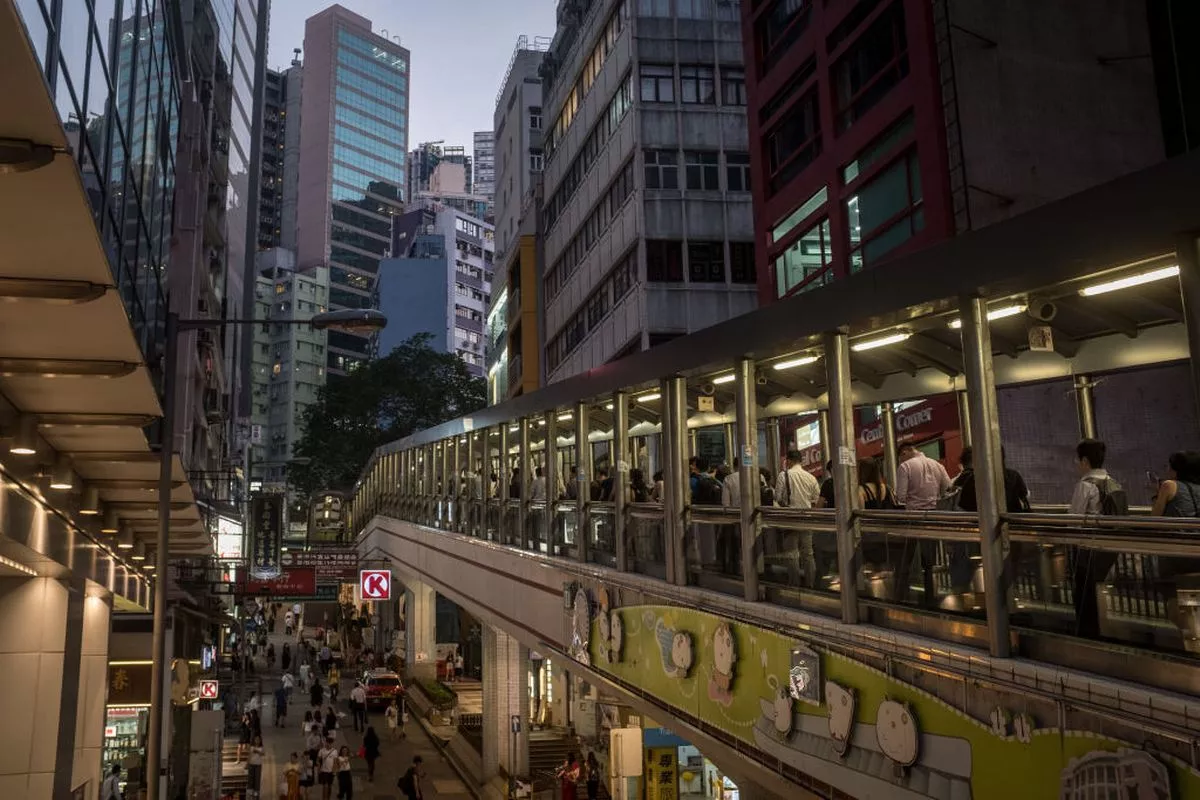 HONG KONG, CHINA - JULY 16: People ride the mid level covered escalators on July 16, 2019 in Hong Kong, China. Hong Kong’s Central–Mid-Levels escalator and walkway system is the longest outdoor covered escalator system in the world and is a major tourist attracti on and ic on of Hong Kong. Hong Kong is approaching a political crossroads after two months of widespread protests over a proposed extradition bill, which raise more fundamental questions about its relationship with mainland China. Since 1997, when it was handed back to China after 156 years of British rule, it has enjoyed a special status governed by the principle of “One Country, Two Systems.” The arrangement gave Hong Kong a high degree of autonomy over domestic affairs, retaining its independent judiciary, rule of law, free trade and free speech. However, its political candidates must be vetted by Beijing, and in the years since the handover, increased Chinese influence has become a major source of tension. In 2014, hundreds of thousands of protesters occupied the central business district for more than three months calling on changes to the electoral system, in what was dubbed the “Umbrella Movement.” With the proposal of the new extradition bill, many Hongkongers see this as another step by China to assert control and have taken to the streets once again. Faced with the backlash, Hong Kong’s chief executive, Carrie Lam, has insisted the bill is “dead,” but protesters have continued weekly rallies and demanded Lam’s resignation. As protests continue to gather momentum, where they will lead is still unknown - calls for full independence remain scarce - but recent rumblings from China’s military suggest a sustained political storm. (Photo by Chris McGrath/Getty Images)