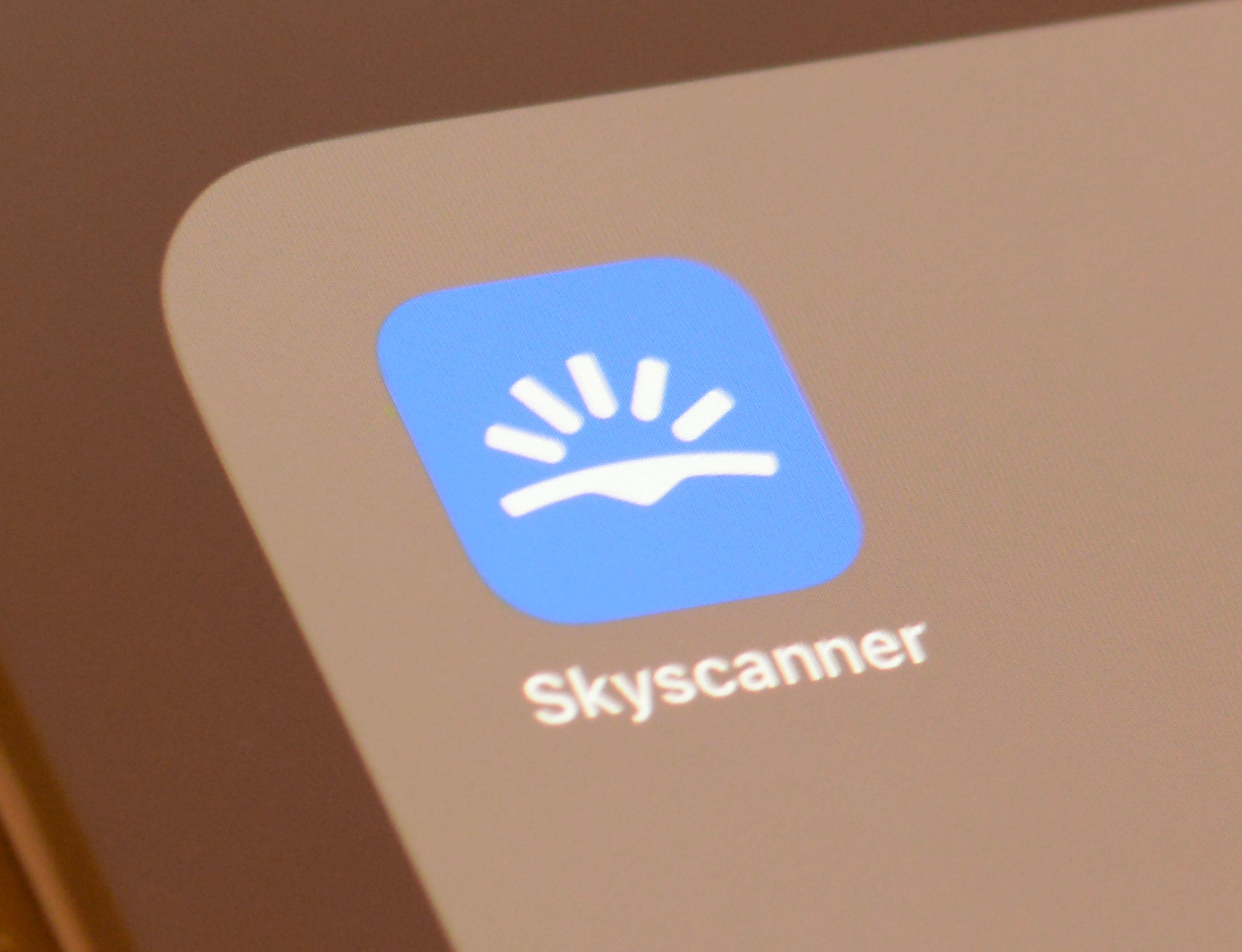 Skyscanner app logo on a smartphone screen.