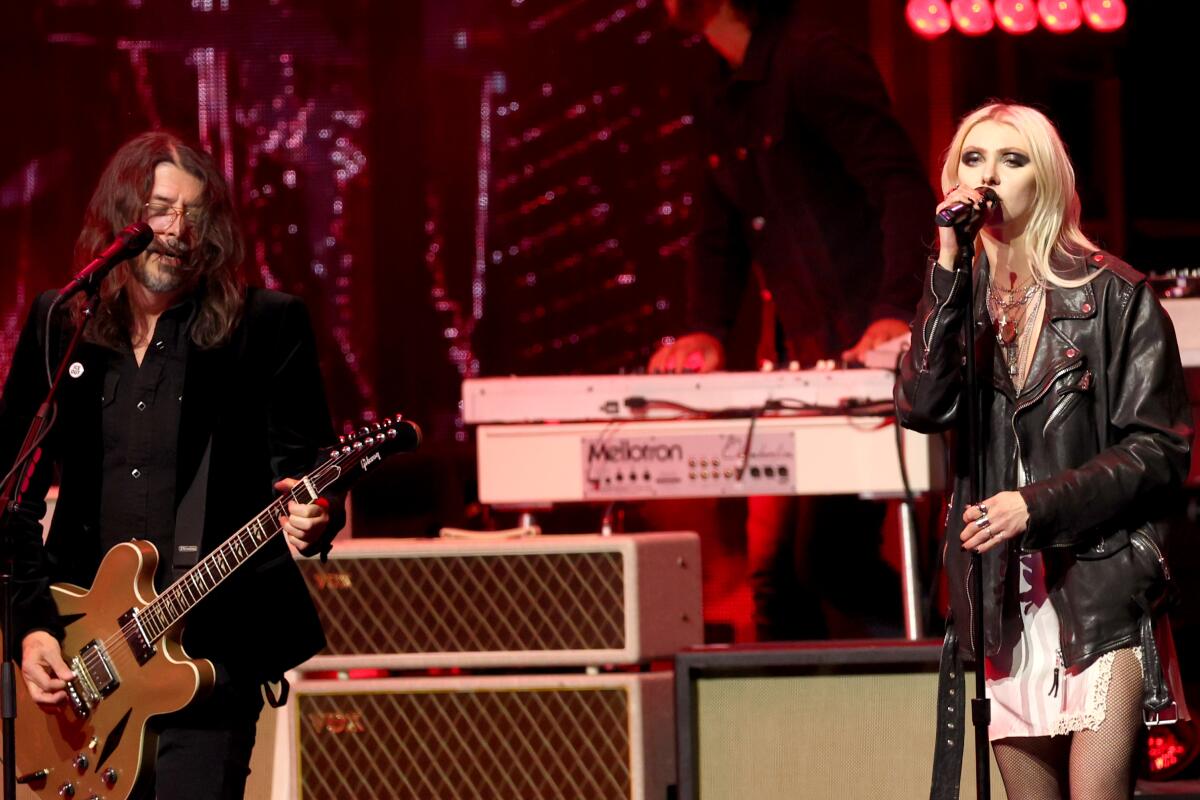 Dave Grohl of Foo Fighters, left, and Taylor Momsen perform.