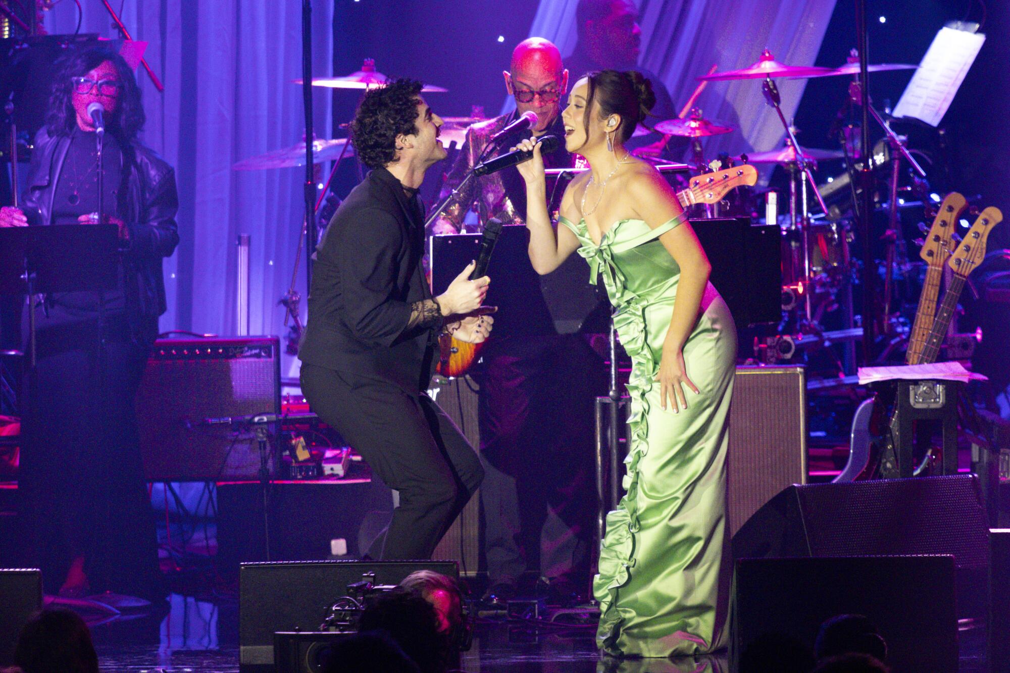 Darren Criss, left, and Laufey perform.