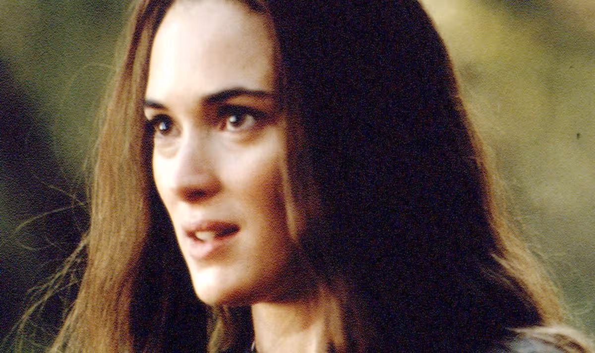 A woman with dark hair looks serious